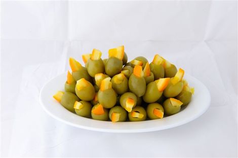 Green stuffed olives with orange