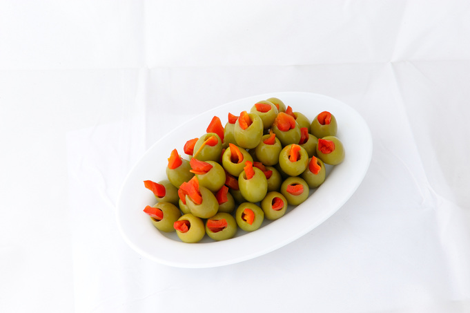 Green stuffed olives with red pepper