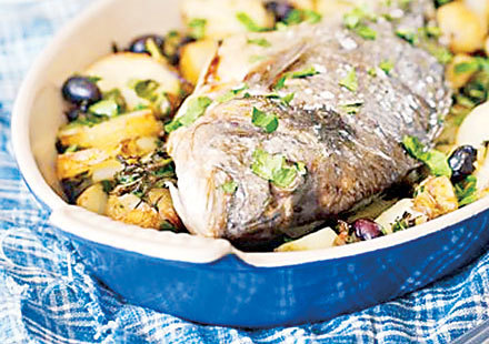 Fish baked with potatoes and olives